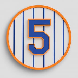 May include: A round wall decoration featuring the number 5 in blue with an orange outline, set against a white background with blue vertical stripes. The outer border is orange.