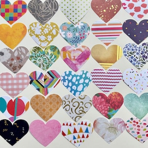 May include: A collection of thirty-two heart-shaped paper cutouts with various patterns and colors. Designs include floral, polka dots, stripes, and abstract shapes. The hearts are arranged on a cream-colored background.
