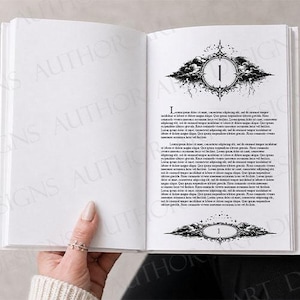 May include: An open book with white pages featuring black printed text and decorative chapter headers. The right page displays the number one inside an ornate, dark, cloud-like frame with star accents at the top and bottom of the page text block.