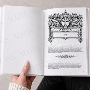 May include: An open book displaying a chapter heading page with the word ONE centred in a decorative black and white frame. The frame features an intricate illustration of a character with long hair and pointed ears. Text blocks follow below.