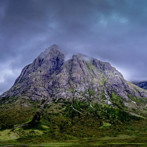 Landscape in Glen coe, rugged bare mountain in Scotland with cloudy weather.