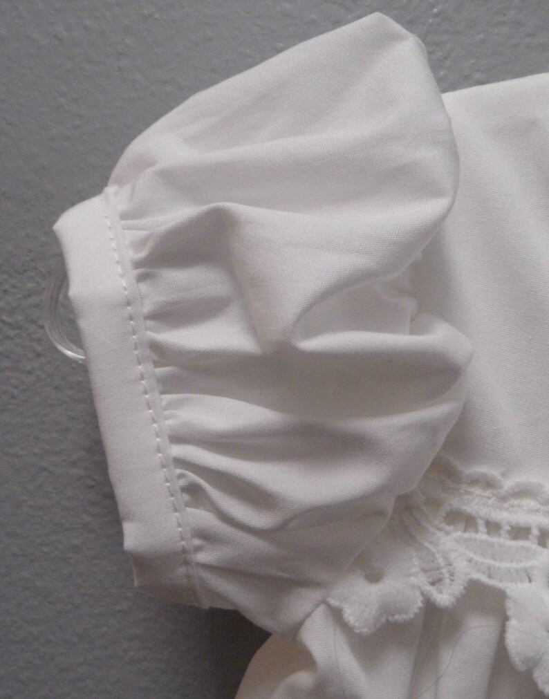 Puede incluir: Blusa blanca de algod&oacute;n con manga abullonada y ribete de encaje.