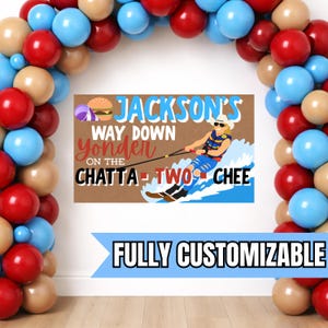 May include: A brown sign with the text "JACKSON'S WAY DOWN yonder ON THE CHATTA - TWO CHEE" and a graphic of a person water skiing. The sign also has a burger and beach ball graphic. The words "FULLY CUSTOMIZABLE" are in a blue banner.