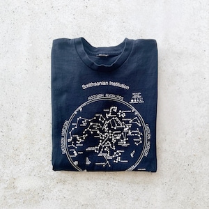 May include: A black t-shirt with a white print of a star chart. The chart is labeled "Smithsonian Institution" and shows the "Southern Horizon" and "Eastern Horizon".