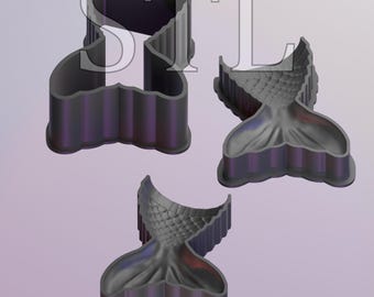 May include: Three dark gray mermaid tail-shaped cookie cutters. The cutters have a detailed design of a mermaid tail, with scales and fins. The cutters are made of a durable material and are suitable for baking or crafting.