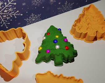 May include: Three Christmas tree cookie cutters, one green and decorated with colorful ornaments, and two orange.