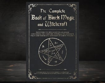 May include: A black book cover with silver lettering that reads "The Complete Book of Black Magic and Witchcraft". The cover also features a silver pentagram with text inside the points.