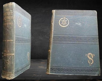 May include: Two antique hardback books with gold lettering on the spines. The book on the left is titled "The Secret Doctrine" by H.P. Blavatsky. The book on the right has a gold star of David symbol on the front cover.