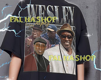 May include: Black oversized t-shirt featuring a graphic of Wesley Snipes with the text "WESLEY" and "PALMASHOP". The shirt is worn by a person. The shirt has a crew neck and short sleeves. The shirt is made of a soft material.