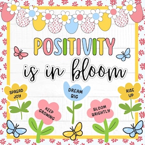 May include: A colorful illustration with the words "Positivity is in bloom." The design features flowers, butterflies, and phrases like "Spread Joy" and "Dream Big." The background is a floral pattern.