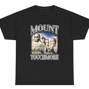 May include: Black t-shirt with a graphic of four men's faces on a mountain with the text "MOUNT TOUCHMORE" in silver lettering.