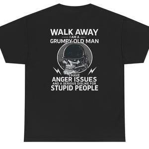 May include: Black t-shirt with a graphic design featuring a skull wearing a helmet and smoking a cigar. The text reads "WALK AWAY I AM A GRUMPY-OLD MAN I HAVE ANGER ISSUES AND A SERIOUS DISLIKE FOR STUPID PEOPLE."