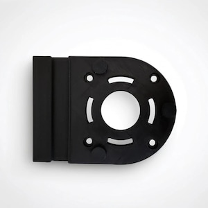 May include: A black, geometric component with a circular center and several smaller holes. The component has a rectangular section attached to one side and is set against a white background.