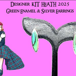 May include: Designer Kit Heath 2025 green enamel and silver earrings. The earrings have a silver frame with a green and turquoise enamel center. The image also features a woman wearing a beret and plaid skirt.