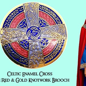 May include: A circular brooch featuring a Celtic cross design with blue and red enamel inlay and gold-toned metal knotwork. The text below reads: CELTIC ENAMEL CROSS BLUE RED & GOLD KNOTWORK BROOCH. A person wears a blue and red garment with gold trim.