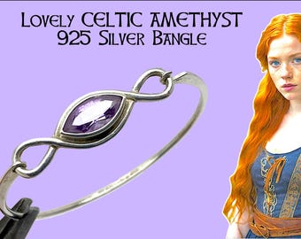 May include: A silver bangle with a Celtic knot design and a central oval-shaped amethyst stone. The text "Lovely Celtic Amethyst 925 Silver Bangle" is displayed at the top. The bangle is displayed against a light purple background.