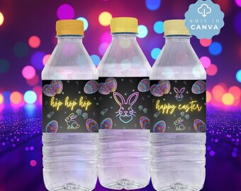May include: Three clear plastic water bottles with yellow caps, each featuring a black label with neon-style graphics of colorful Easter eggs and rabbits. The labels display the text "hop hop hop" and "happy easter" in a yellow script font.