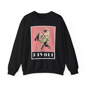 May include: Black sweatshirt with a pink and white graphic of a couple dancing. The graphic is framed in a black border and the word "RIVOLI" is printed below the graphic.