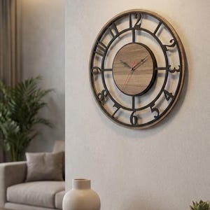 May include: A round wall clock with a wooden face and black metal frame. The clock has black numerals and hands, and is mounted on a light-coloured wall. The clock is approximately 46 cm in diameter.
