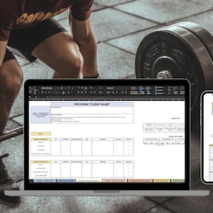 May include: A laptop computer displaying a spreadsheet with the title "PROGRAM "CLIENT NAME"". A smartphone displaying a spreadsheet with the title "GOAL PLATE DIVISION" is next to the laptop. A person is lifting weights in the background.