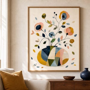 May include: A framed wall art print featuring a stylized floral arrangement in a wide, segmented vase. The artwork displays a cream background with flowers in shades of pink, blue, and yellow, accented by green leaves and scattered petals throughout the composition.
