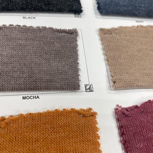 May include: Fabric swatches in black, navy, mocha, orange, and pink. The swatches are labeled with the color names.