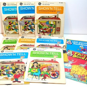 May include: A collection of vintage "Show 'N Tell" picture sound programs, featuring Disney characters and classic stories. The covers display colorful illustrations and the "Show 'N Tell" logo. Titles include "Alice in Wonderland," "Lady and the Tramp," and "The Pied Piper."