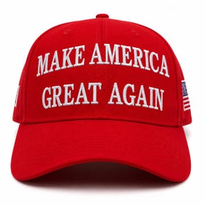 May include: A bright red baseball cap featuring the white embroidered text MAKE AMERICA GREAT AGAIN across the front crown. The cap includes a small embroidered American flag detail on the side panel, a structured six-panel design, and a curved brim.