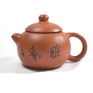 May include: A set of three ceramic mugs with a speckled, matte finish. The mugs are in shades of cream, light gray, and dark gray. Each mug has a simple, minimalist design, perfect for coffee or tea.