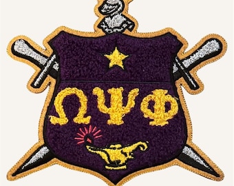 May include: A purple shield-shaped embroidered patch featuring the gold Greek letters Omega, Psi, and Phi. The design includes a gold star, a gold lamp with red rays, two crossed silver swords, and a silver knight helmet crest with a red plume.