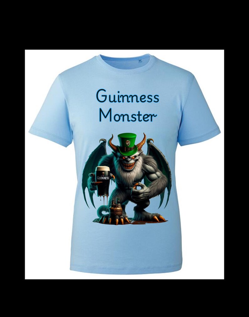 May include: Light blue t-shirt with a graphic of a green-skinned monster wearing a green hat and holding a glass of Guinness. The text "Guinness Monster" is printed on the shirt.