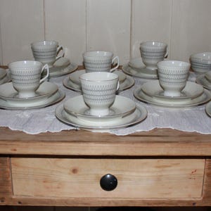 May include: A set of three ceramic nesting bowls in shades of blue, green, and white. The bowls feature a speckled glaze and a simple, modern design. The largest bowl measures approximately 6 inches in diameter.