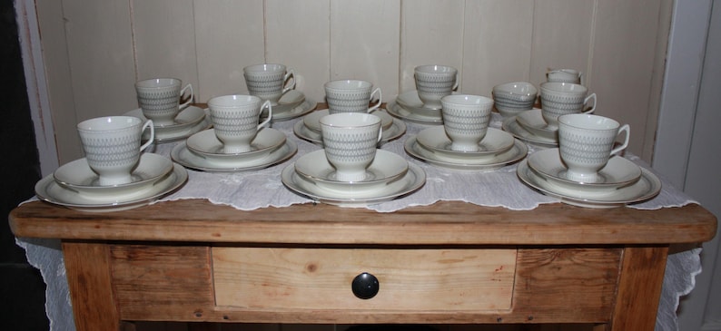 May include: A set of three ceramic nesting bowls in shades of blue, green, and white. The bowls feature a speckled glaze and a simple, modern design. The largest bowl measures approximately 6 inches in diameter.