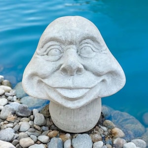 Massive mushroom with tongue out statue, Concrete face mushroom sculpture, Stone toadstool, Fairy toadstool decoration