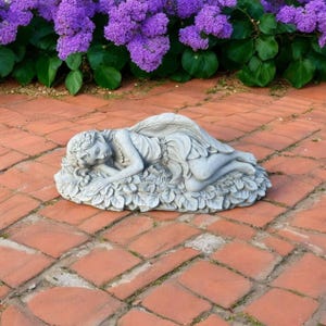 May include: A white ceramic mug with a black handle and the text "But First, Coffee" in a bold, black font. The mug is set against a blurred background, suggesting a cozy setting.