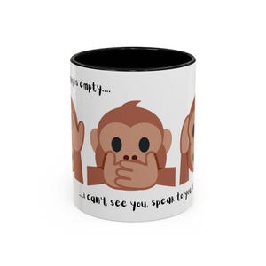Puede incluir: Taza de cerámica blanca con interior negro que presenta tres emojis de monos marrones. Cada emoji representa "No ver el mal, no oír el mal, no hablar el mal". El texto en la taza dice: "...mi taza está vacía... No puedo verte, hablar contigo."