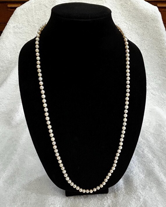Pearl necklace. 14 K fish hook clasp. Opera length.