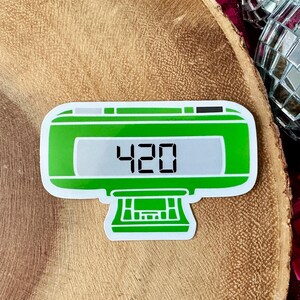 May include: Green and white sticker of a digital clock displaying the number 420.