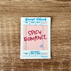 May include: A sticker resembling a guest check with the words "Guest Check" in blue and "SPICY ROMANCE" in red. The sticker has a pink center with blue lines and the text "THE HAUS OF HOLLY" at the bottom.
