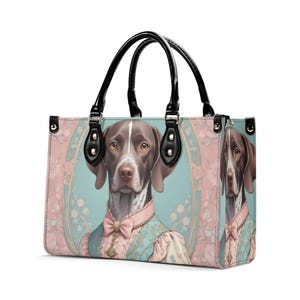 May include: A brown and white dog wearing a blue and pink patterned vest and a pink bow tie. The dog is depicted on a pink and blue tote bag with a black handle.
