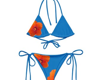 May include: A blue bikini with orange hibiscus flower print. The top is a triangle style with adjustable straps. The bottom is a cheeky style with ties on the sides.