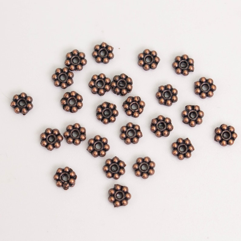 Cuentas espaciadoras de margaritas con acabado en cobre antiguo - 4 mm (300 unidades) - Lote al por mayor imagen 1