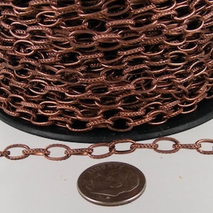 Corrente de cabo com acabamento em cobre antigo: elos ovais texturizados em ferro (9x4,5 mm) 1,5 metro - 945TEX
