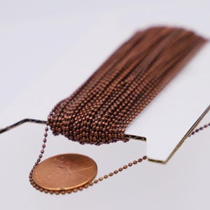 Muestra de cadena de bolas facetada con acabado color bronce: 1,2 mm con 100 conectores, 300 pies - Lote al por mayor - DC1.2