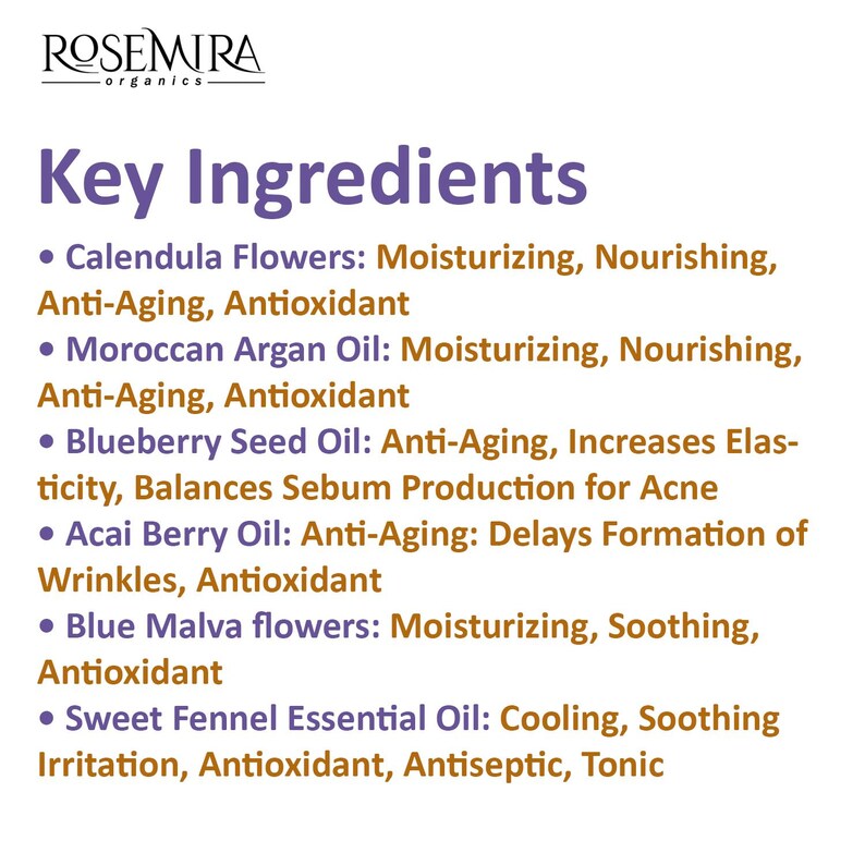 May include: A white background with black text listing key ingredients and their benefits. The ingredients include Calendula Flowers, Moroccan Argan Oil, Blueberry Seed Oil, Acai Berry Oil, Blue Malva flowers, and Sweet Fennel Essential Oil.