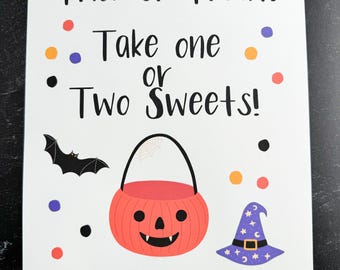May include: A white sign with black text that reads "Trick or Treat! Take one or Two Sweets!"  There is a black bat, a pumpkin-shaped candy bucket, and a purple witch's hat with white stars and a crescent moon on the sign. There are also colorful dots scattered around the sign.