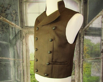 May include: A brown double-breasted vest with dark buttons and a notched lapel. The vest is displayed on a mannequin. The fabric has a subtle textured pattern. The vest has two front pockets.