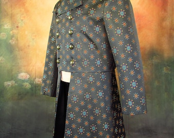 May include: A black frock coat with a geometric pattern in shades of orange, blue, and gold. The coat has a double-breasted closure and a long tail.