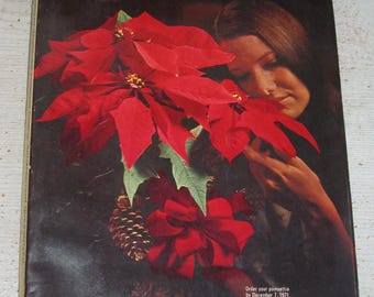 May include: A 1971 Montgomery Ward Christmas catalog featuring a cover with a large red poinsettia plant, a pinecone, and a red ribbon. The text reads Montgomery Ward 1971 Christmas Catalog Index Page 252 Albany, N.Y. 12201 and order details.