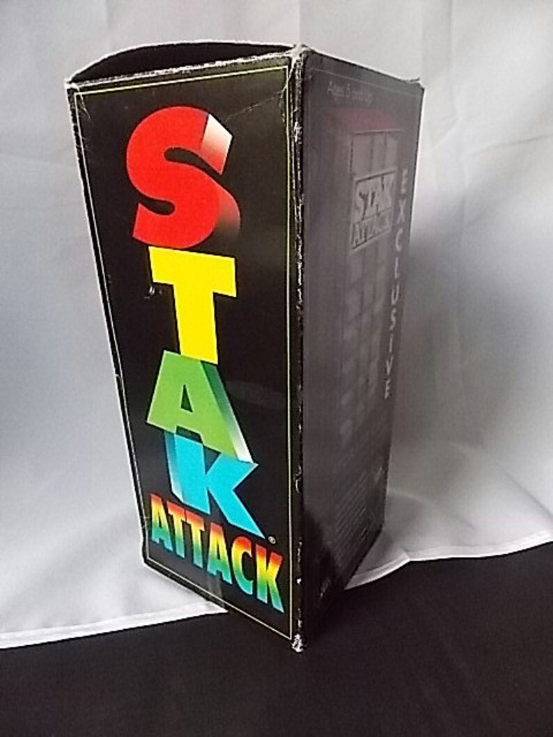 May include: A black box with the words "STAR ATTACK" in large, colorful letters. The letters are red, yellow, green, and blue. The box has the words "EXCLUSIVE" and "Ages 5 and up" printed on the side.